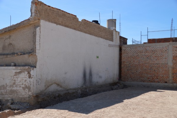The only remaining wall from the original building. It still has an evacuation route notice.