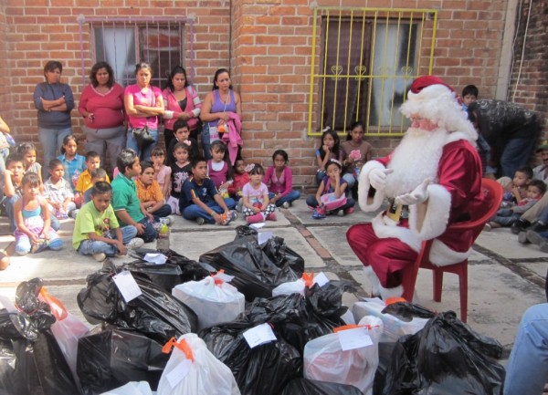 Santa gets the kids' attention -- but a few are focused on the bags of presents.