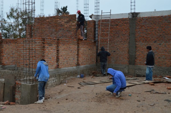 The squatting worker is in the middle of the large classroom we'll be using for the Institute.