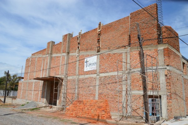 This week the outside facade has gone up. The roof itself will be angled, but the outside is built to make it look level. On the right-hand (northeast) corner, we'll have a tower.